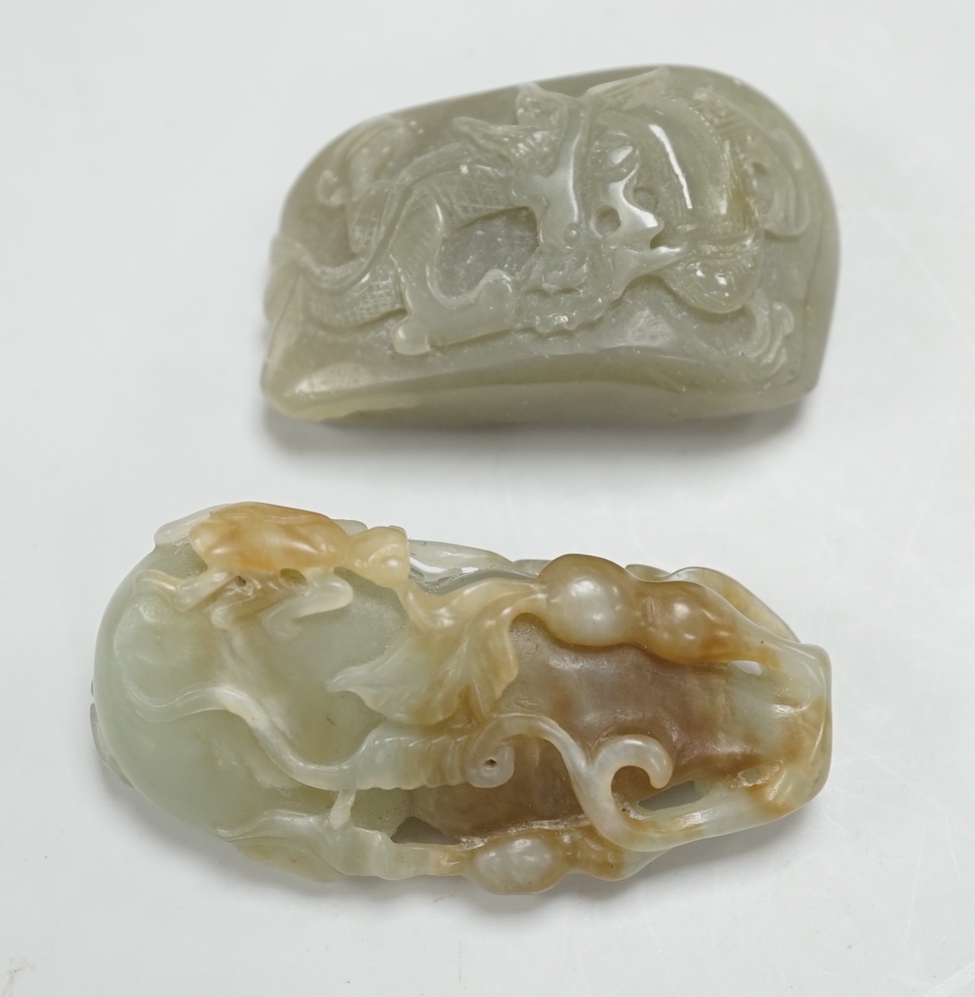 A Chinese green and russet green and brown jade carving of gourd and a green jade pebble carved in relief with a dragon, largest 6.5cm high (2)